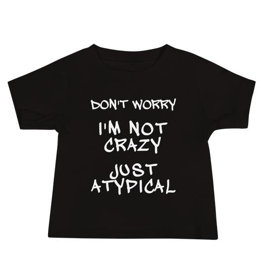 "Don't Worry I'm Not Crazy Just Atypical" printed on a black baby jersey short sleeve tee laying on a flat surface