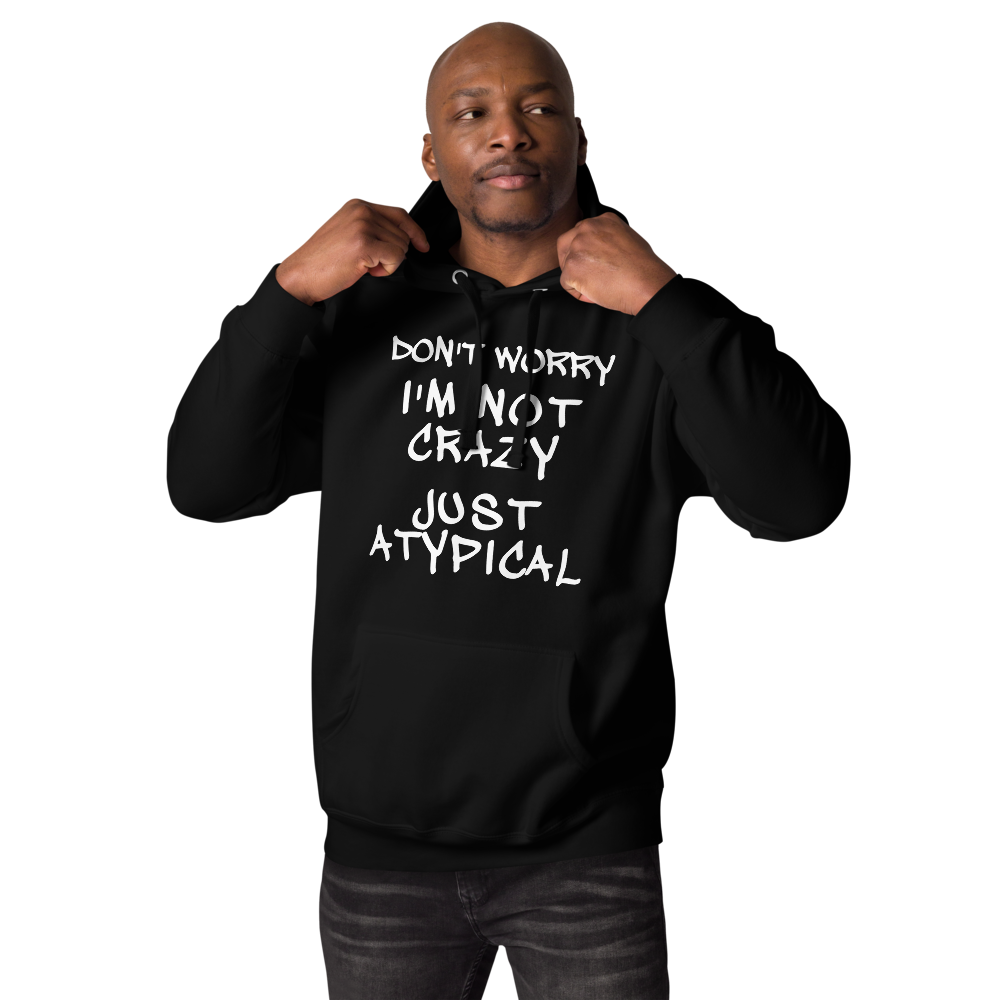 "Don't Worry I'm Not Crazy Just Atypical" printed on a black unisex hoodie worn by a male