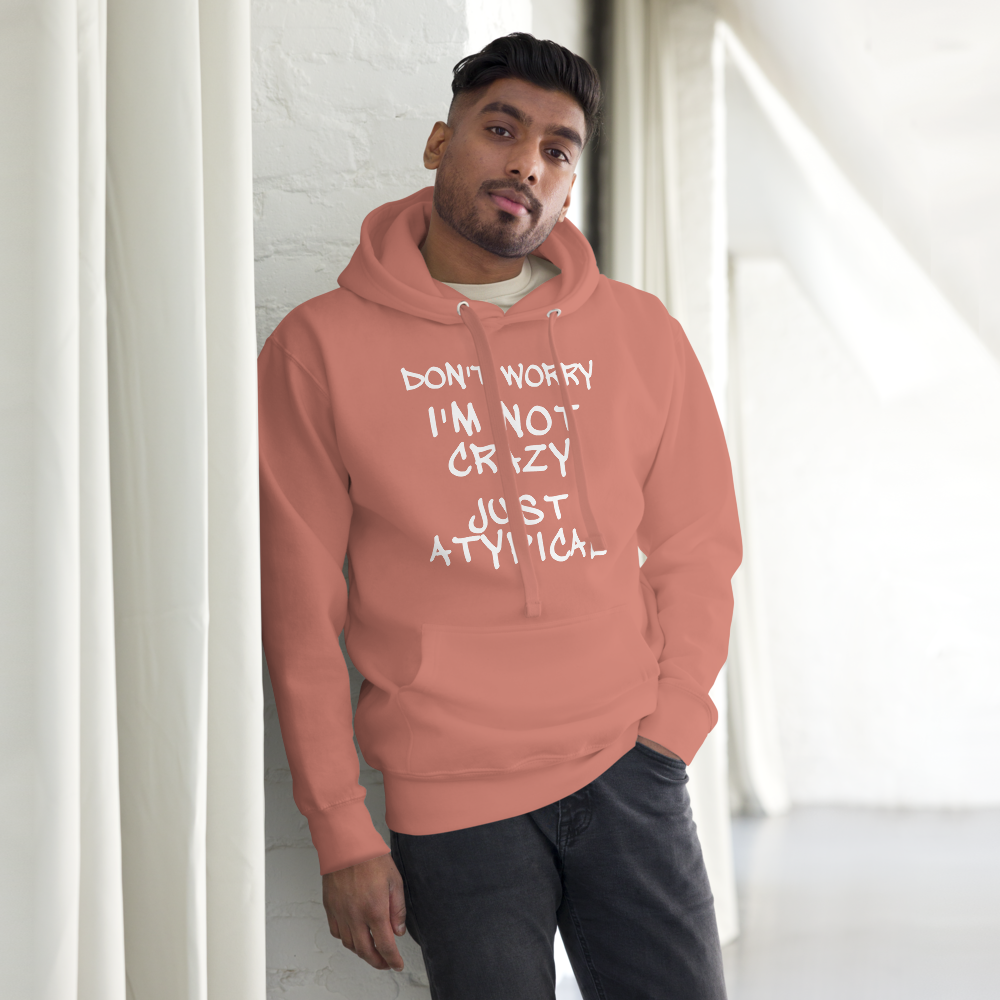 "Don't Worry I'm Not Crazy Just Atypical" printed on a dusty rose unisex hoodie worn by a male