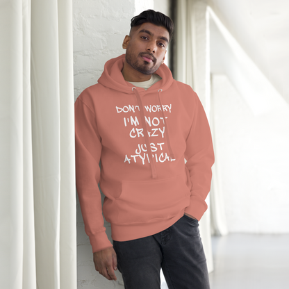 "Don't Worry I'm Not Crazy Just Atypical" printed on a dusty rose unisex hoodie worn by a male
