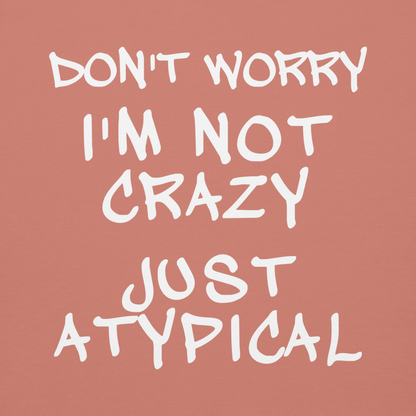 "Don't Worry I'm Not Crazy Just Atypical" printed on a dusty rose background