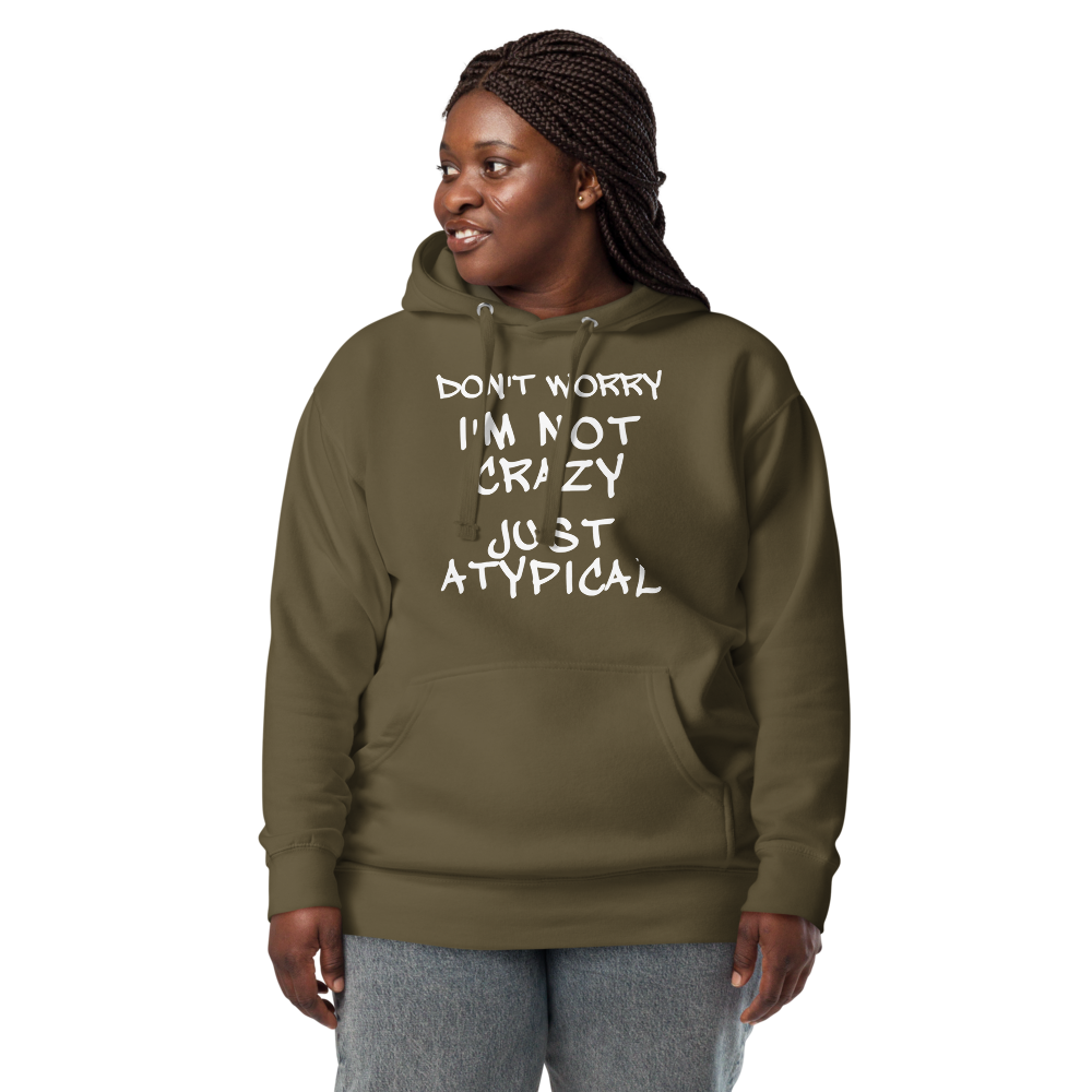"Don't Worry I'm Not Crazy Just Atypical" printed on a military green unisex hoodie worn by a female