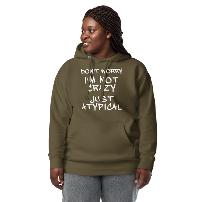 "Don't Worry I'm Not Crazy Just Atypical" printed on a military green unisex hoodie worn by a female