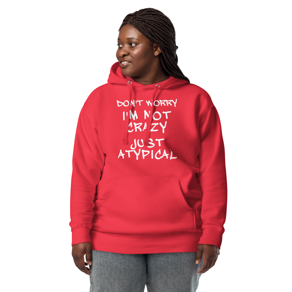 "Don't Worry I'm Not Crazy Just Atypical" printed on a team red unisex hoodie worn by a female