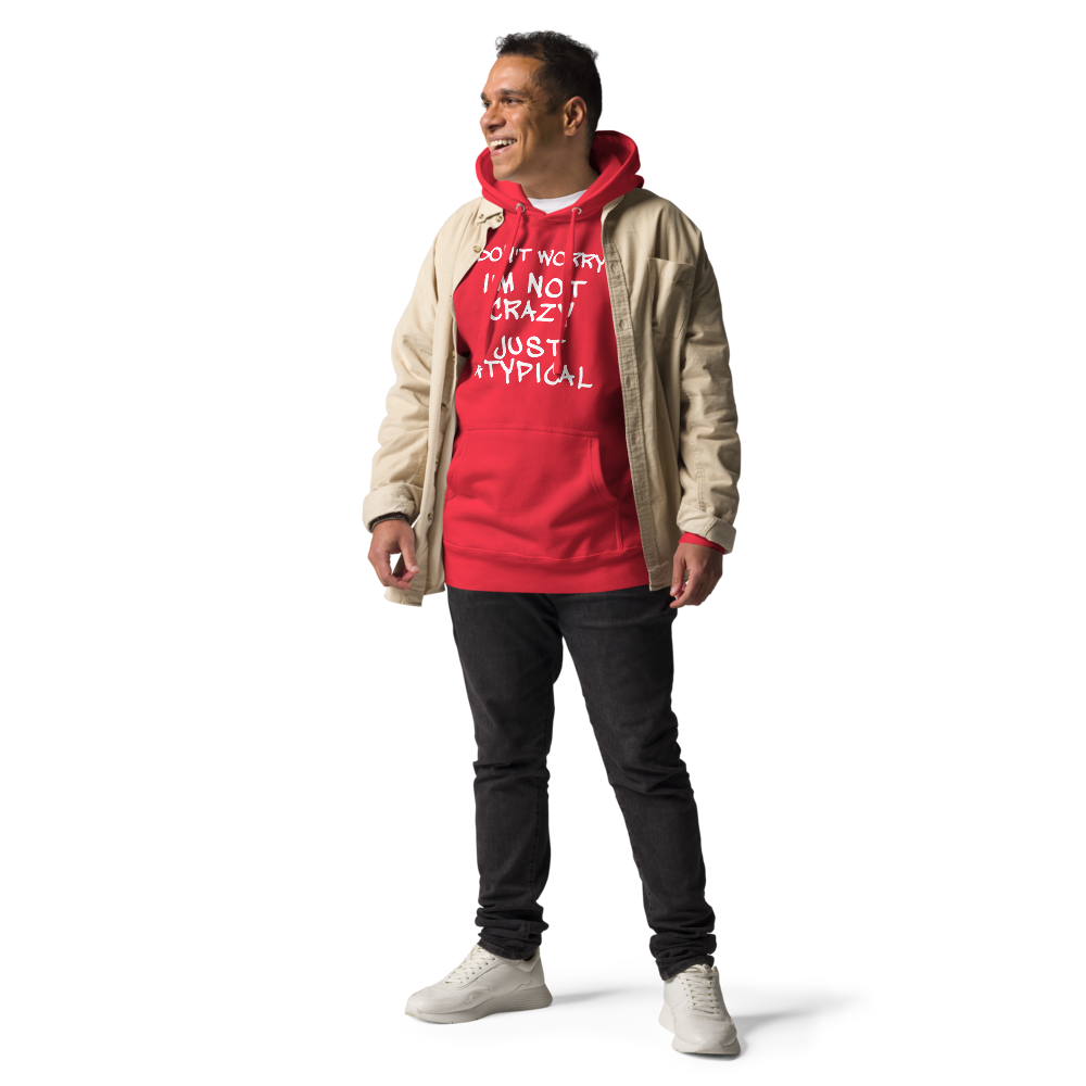 "Don't Worry I'm Not Crazy Just Atypical" printed on a team red unisex hoodie worn by a male with a jacket on top