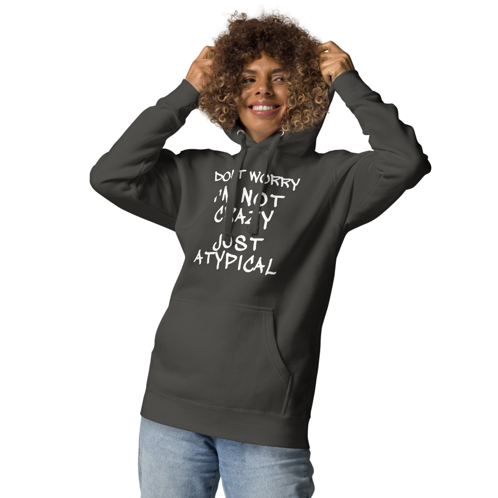 "Don't Worry I'm Not Crazy Just Atypical" printed on a vintage black unisex hoodie worn by a female
