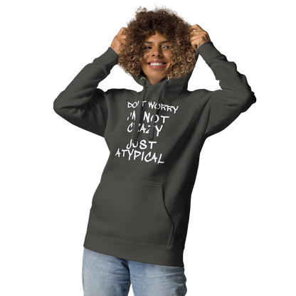 "Don't Worry I'm Not Crazy Just Atypical" printed on a vintage black unisex hoodie worn by a female