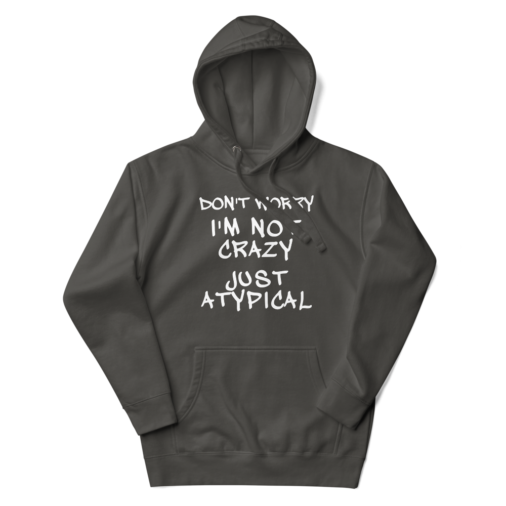 "Don't Worry I'm Not Crazy Just Atypical" printed on a vintage black unisex hoodie laying on a flat surface with the hood up