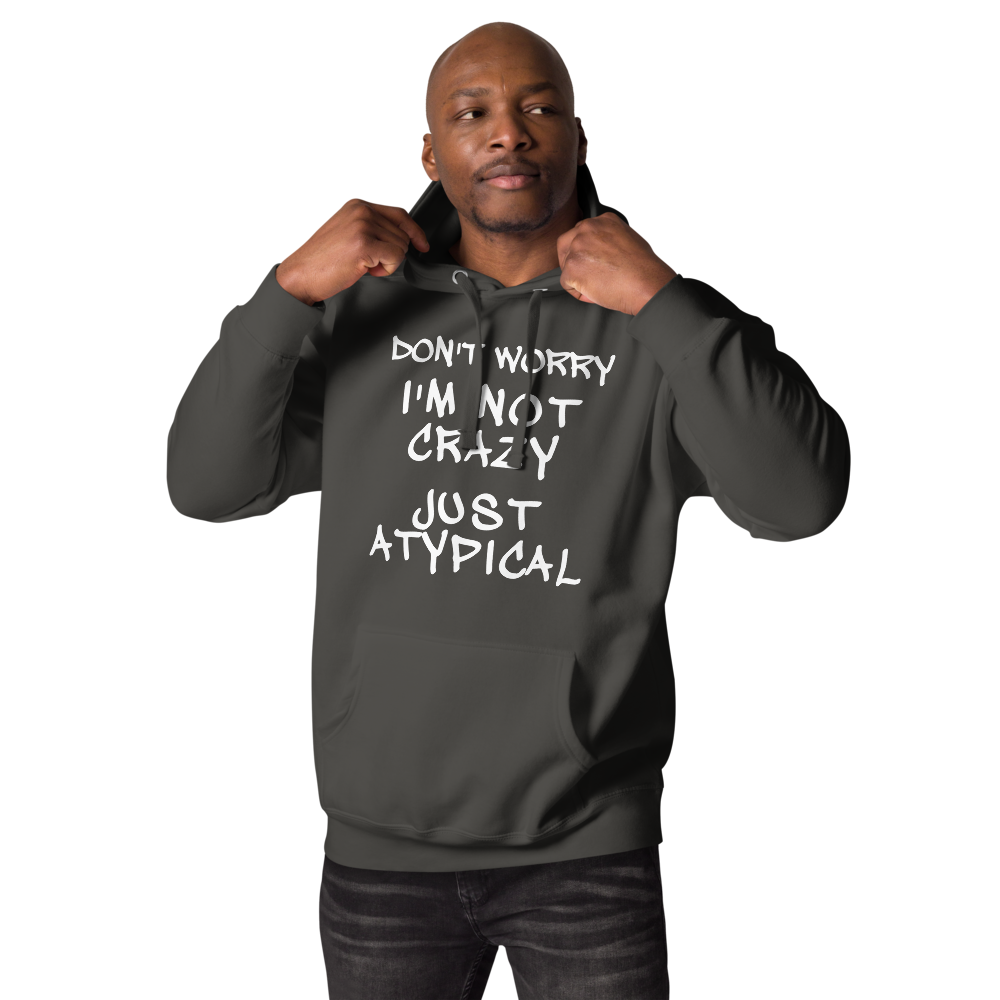 "Don't Worry I'm Not Crazy Just Atypical" printed on a vintage black unisex hoodie worn by a male