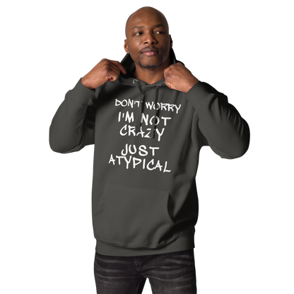 "Don't Worry I'm Not Crazy Just Atypical" printed on a vintage black unisex hoodie worn by a male