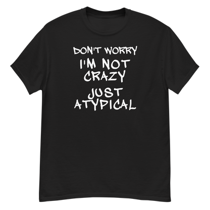 "Don't Worry I'm Not Crazy Just Atypical" printed on a black unisex classic tee laying on a flat surface