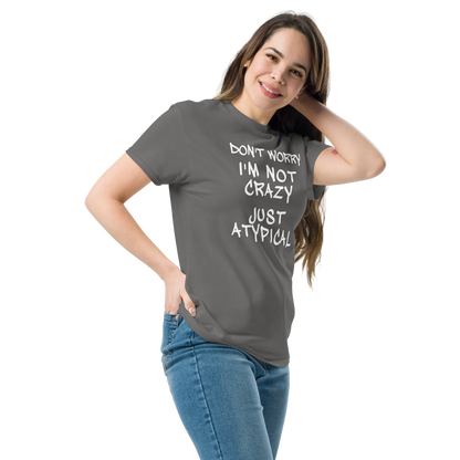 "Don't Worry I'm Not Crazy Just Atypical" printed on a charcoal unisex classic tee worn by a female