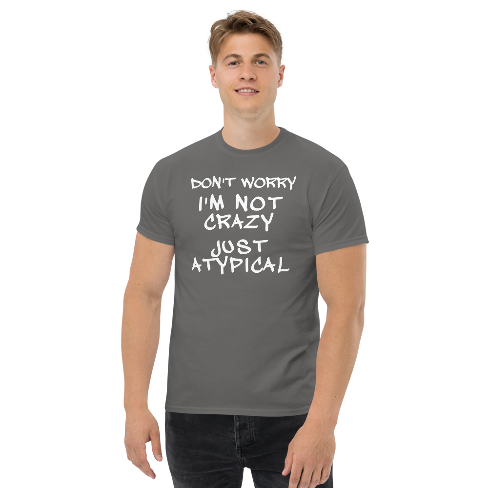 "Don't Worry I'm Not Crazy Just Atypical" printed on a charcoal unisex classic tee worn by a male