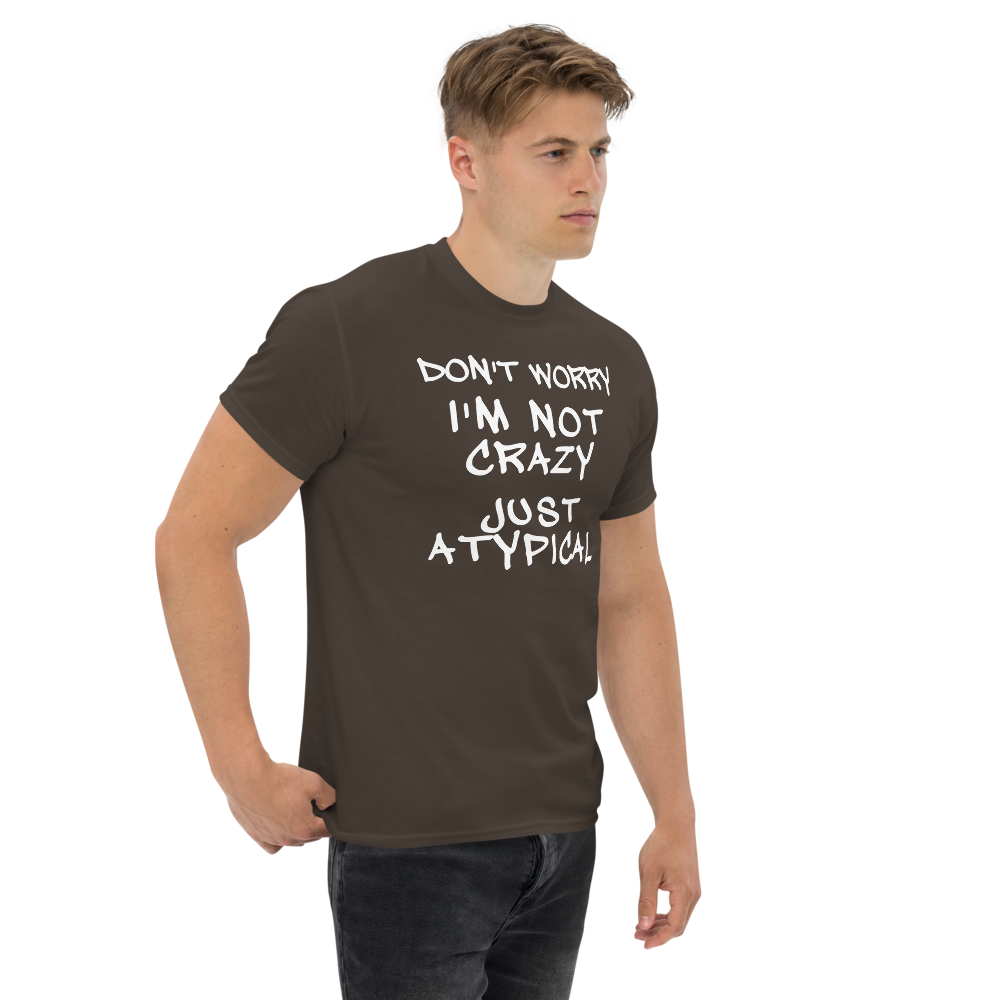 "Don't Worry I'm Not Crazy Just Atypical" printed on a dark chocolate unisex classic tee worn by a male