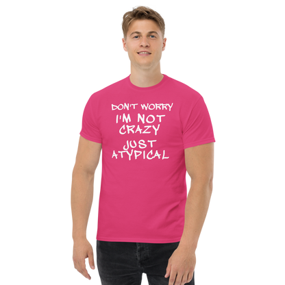 "Don't Worry I'm Not Crazy Just Atypical" printed on a heliconia unisex classic tee worn by a male