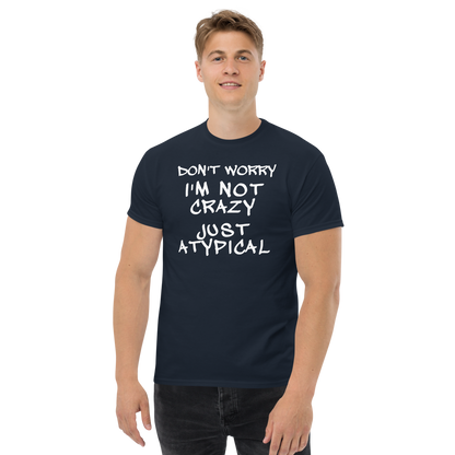 "Don't Worry I'm Not Crazy Just Atypical" printed on a navy unisex classic tee worn by a male