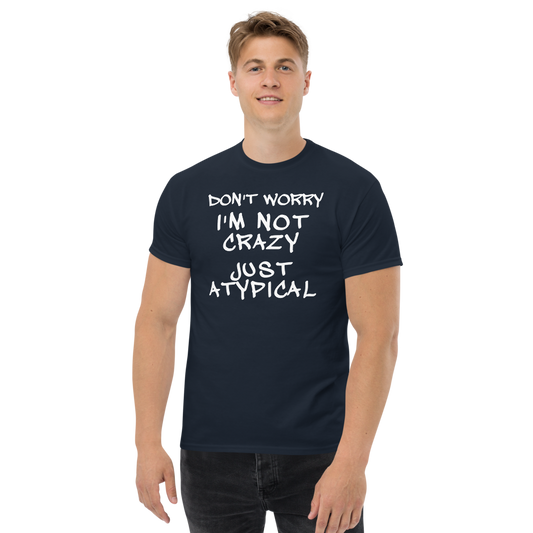 "Don't Worry I'm Not Crazy Just Atypical" printed on a navy unisex classic tee worn by a male