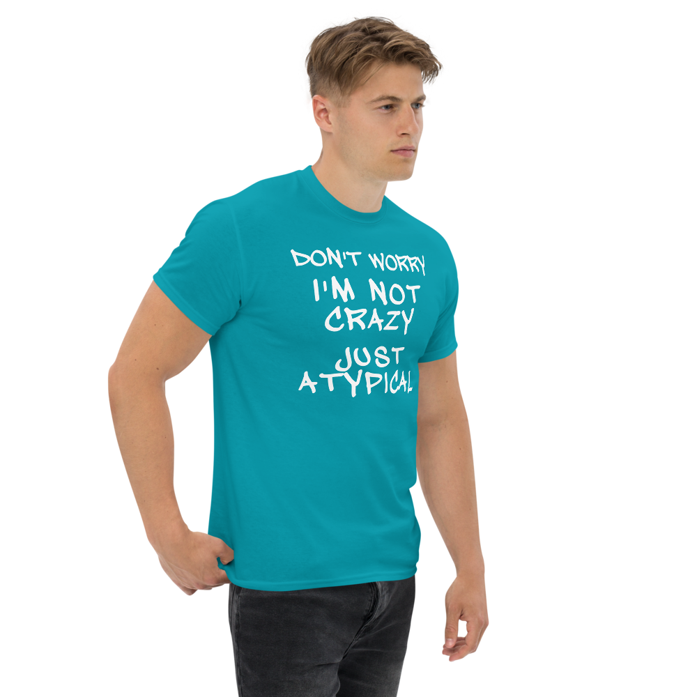 "Don't Worry I'm Not Crazy Just Atypical" printed on a tropical blue unisex classic tee worn by a male