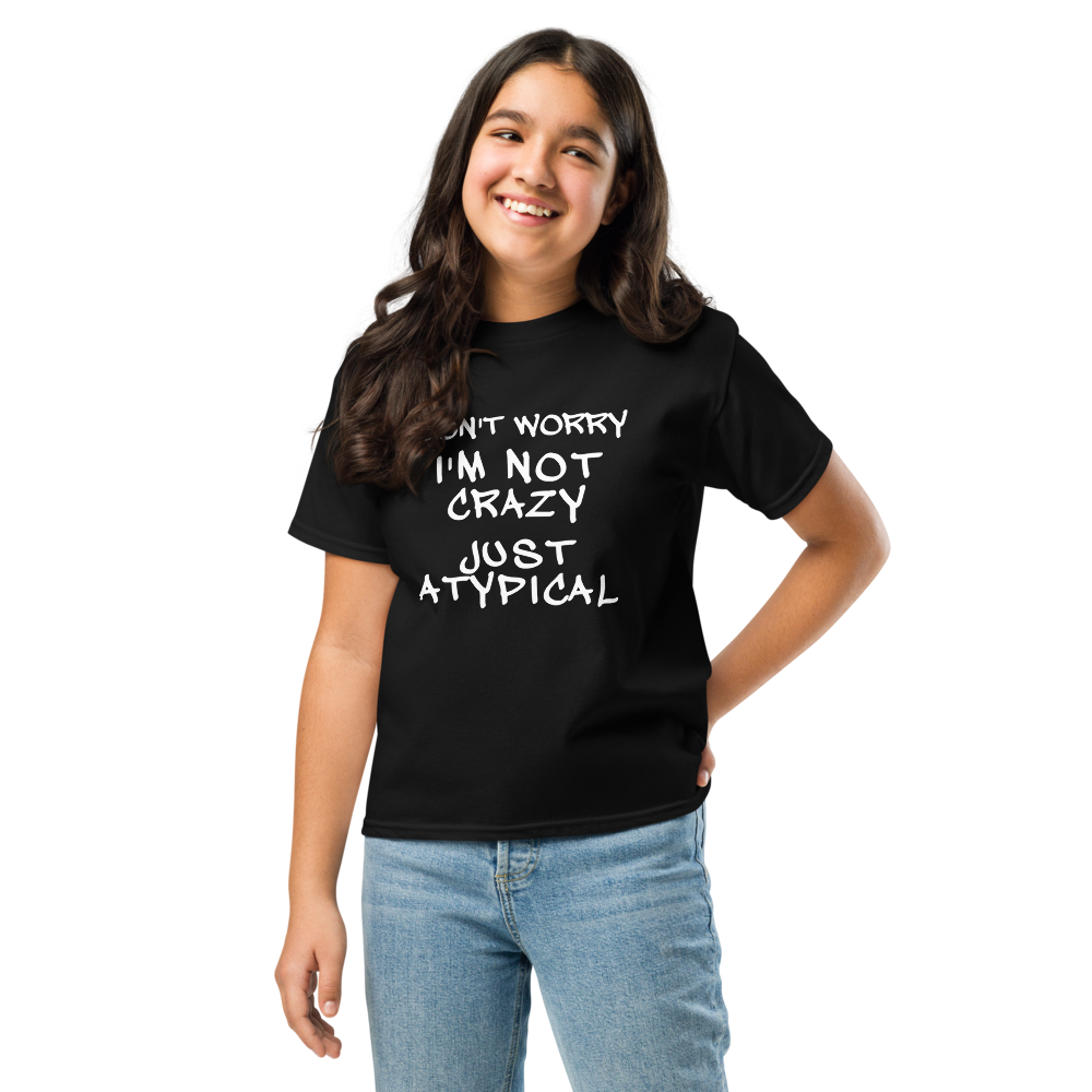 "Don't Worry I'm Not Crazy Just Atypical" printed on a black youth classic tee worn by a female