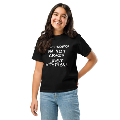 "Don't Worry I'm Not Crazy Just Atypical" printed on a black youth classic tee worn by a female