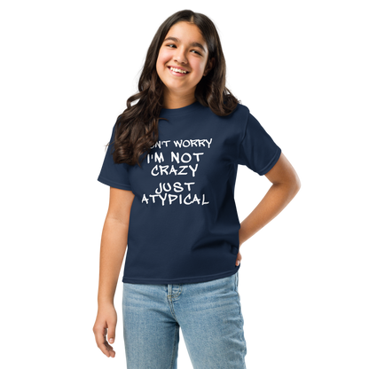 "Don't Worry I'm Not Crazy Just Atypical" printed on a navy youth classic tee worn by a female
