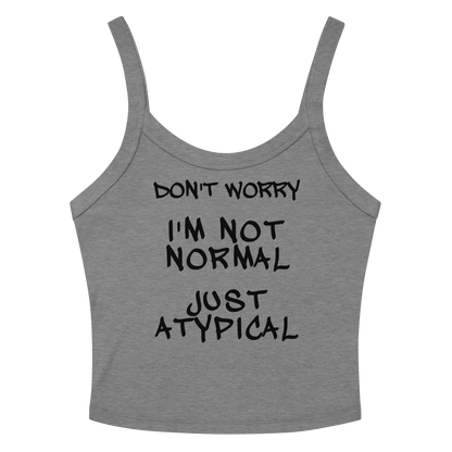 "Don't Worry I'm Not Normal Just Atypical" printed on a athletic heather women's micro-rib tanktop laying on a flat surface amongst sunglasses and shorts