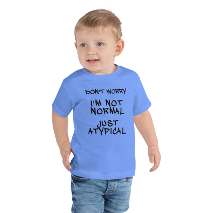 "Don't Worry I'm Not Normal Just Atypical" printed on a heather columbia blue toddler short sleeve tee worn by a male