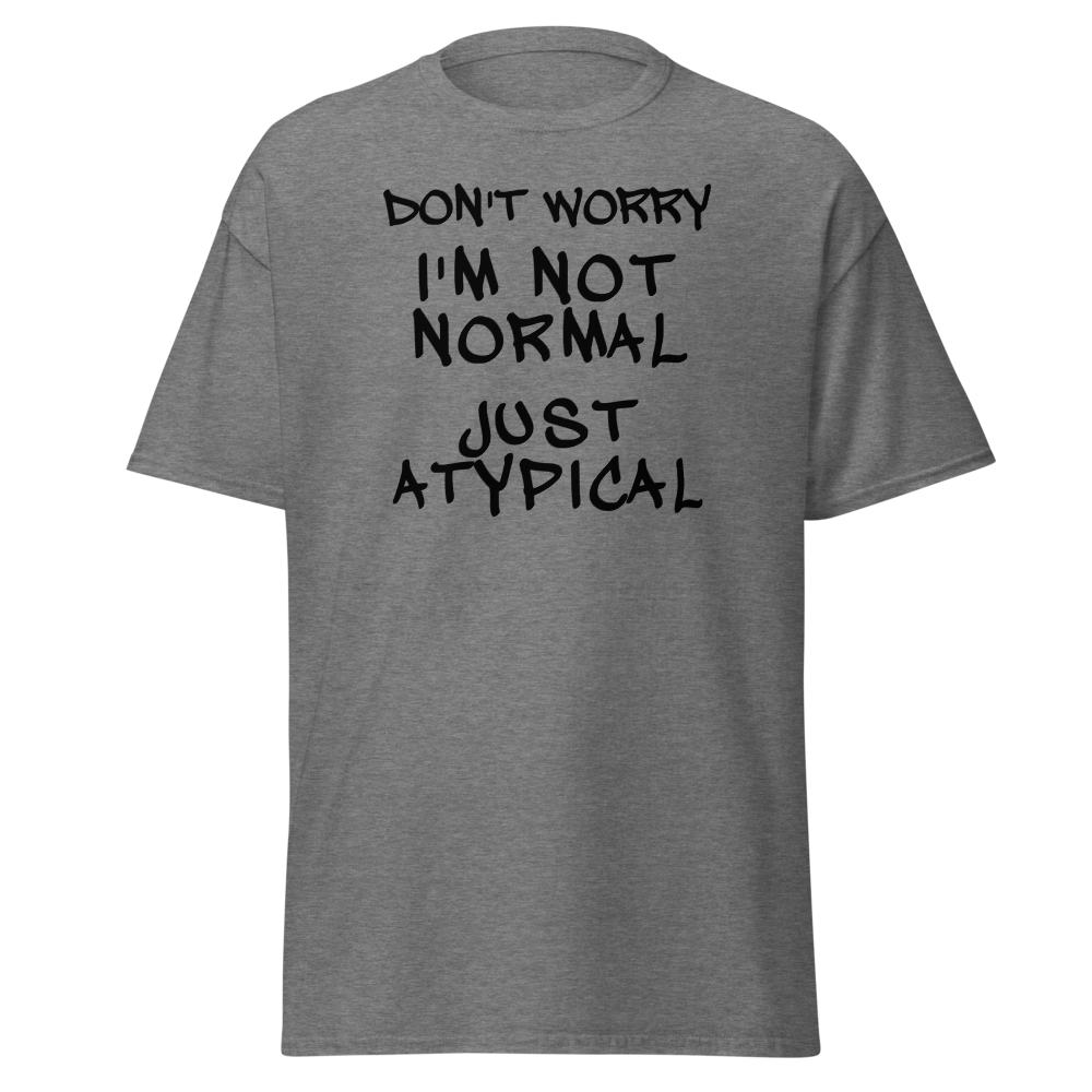 "Don't Worry I'm Not Normal Just Atypical" printed on a graphite heather unisex classic tee laying on a flat surface