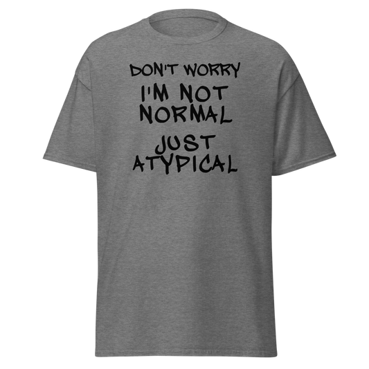 "Don't Worry I'm Not Normal Just Atypical" printed on a graphite heather unisex classic tee laying on a flat surface