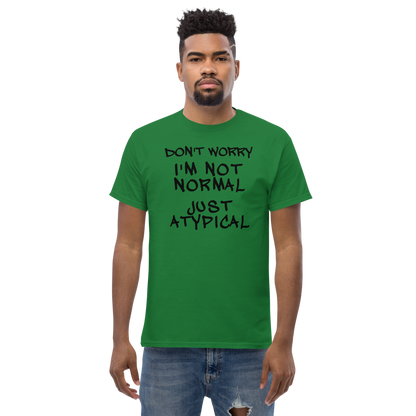"Don't Worry I'm Not Normal Just Atypical" printed on a turf green unisex classic tee worn by a male
