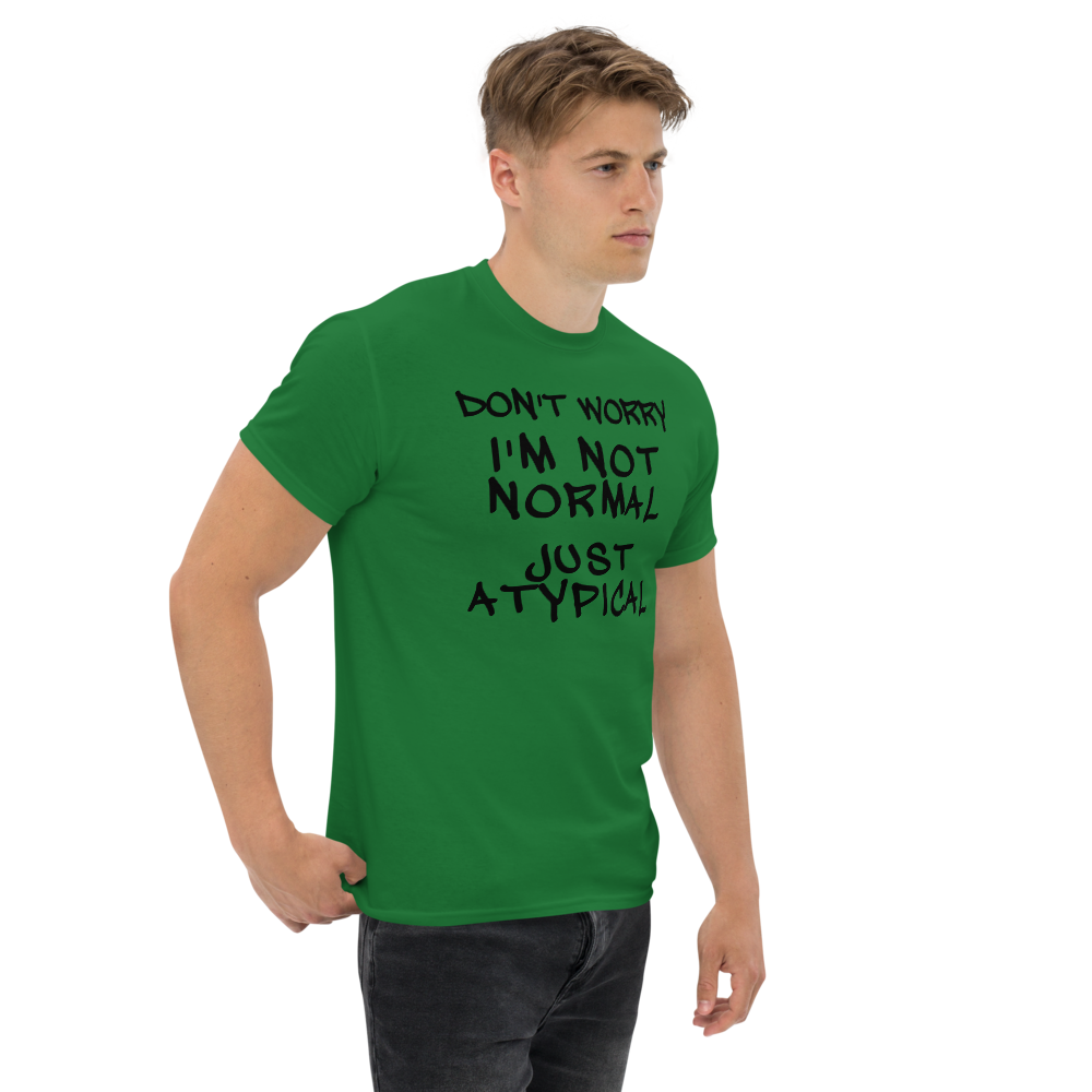 "Don't Worry I'm Not Normal Just Atypical" printed on a turf green unisex classic tee worn by a male