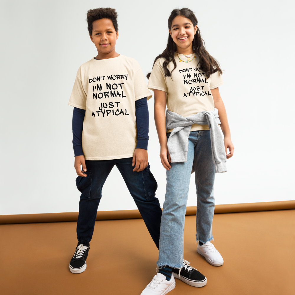 "Don't Worry I'm Not Normal Just Atypical" printed on a natural youth classic tee worn by a female and male