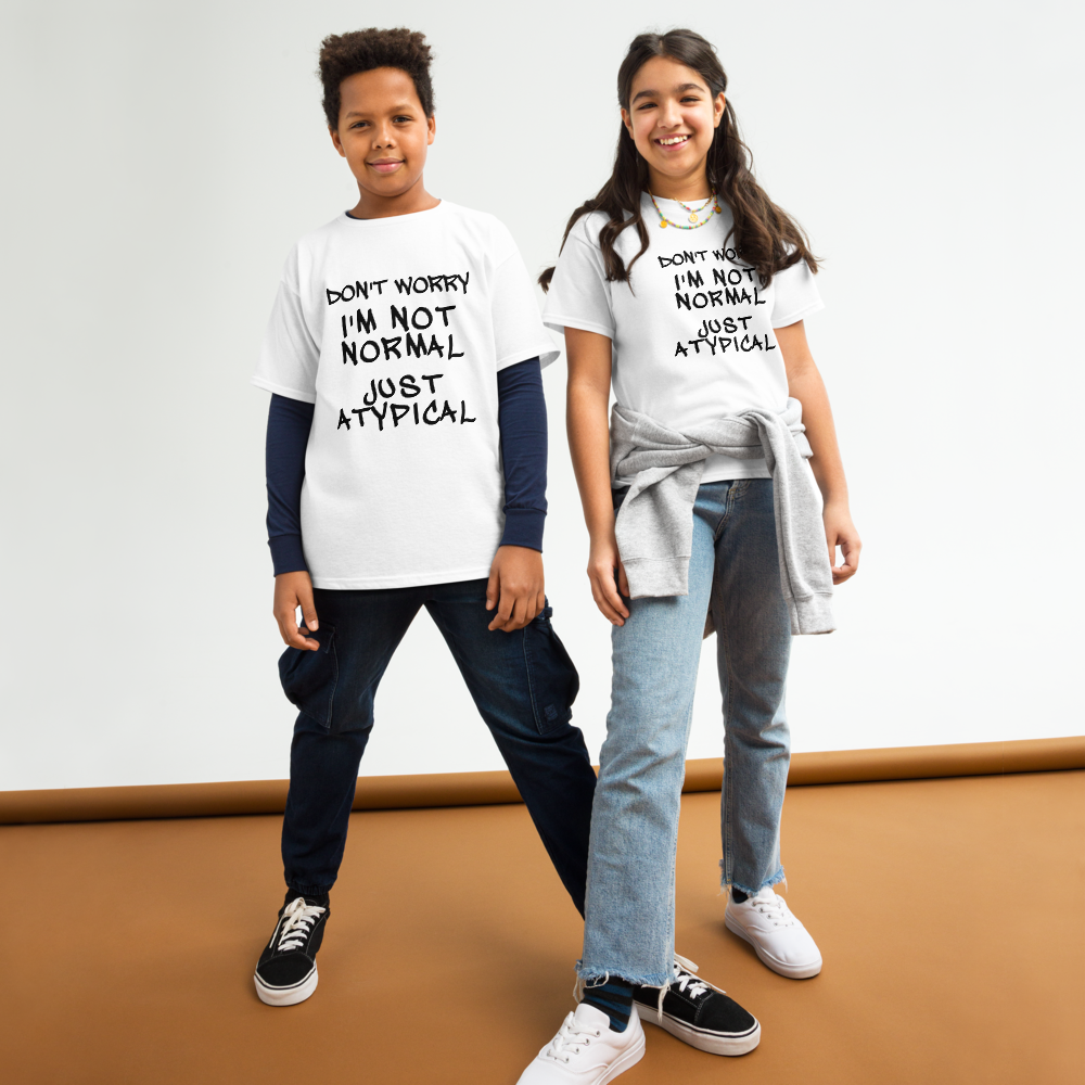 "Don't Worry I'm Not Normal Just Atypical" printed on a white youth classic tee worn by a female and male