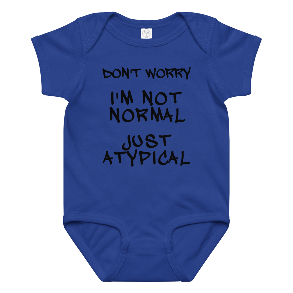 "Don't Worry I'm Not Normal Just Atypical" printed on a royal baby jersey bodysuit laying on a flat surface amongst other clothes