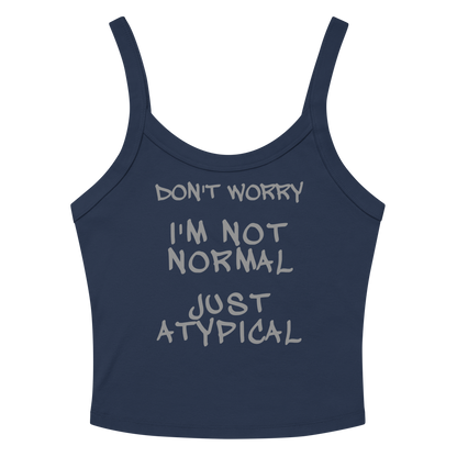 "Don't Worry I'm Not Normal Just Atypical" printed on a solid navy blend women's micro-rib tanktop laying on a flat surface amongst sunglasses and shorts