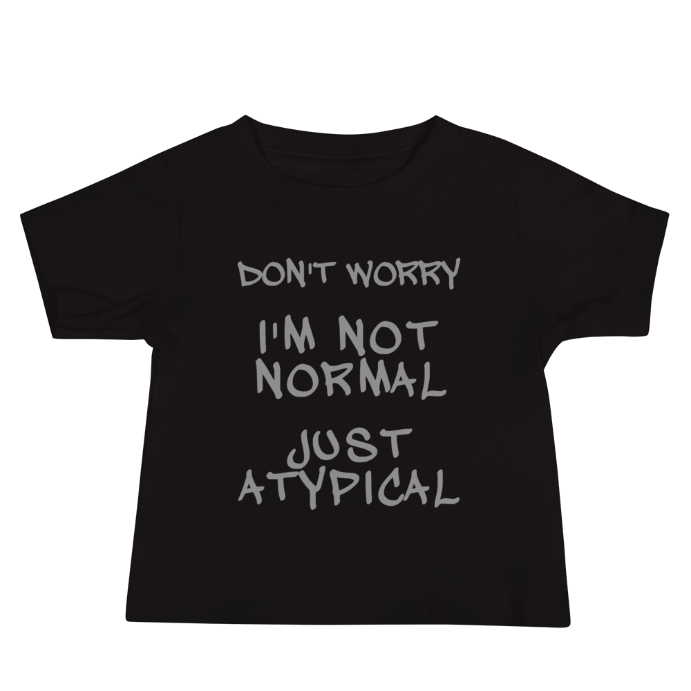 "Don't Worry I'm Not Normal Just Atypical" printed on a black baby jersey short sleeve tee laying on a flat surface