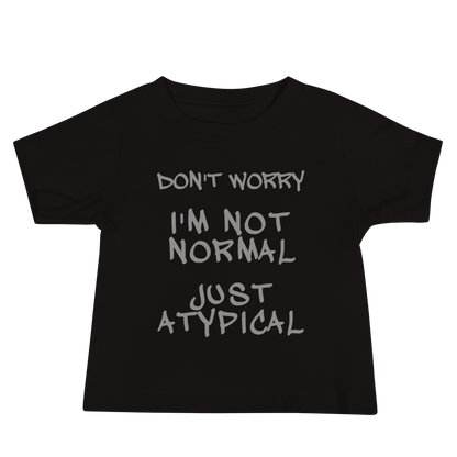 "Don't Worry I'm Not Normal Just Atypical" printed on a black baby jersey short sleeve tee laying on a flat surface