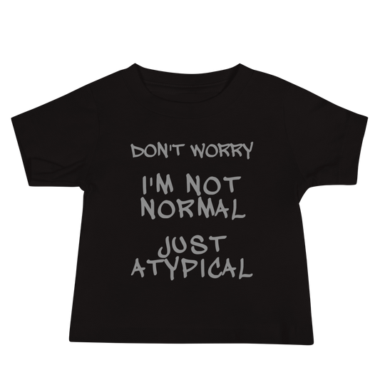"Don't Worry I'm Not Normal Just Atypical" printed on a black baby jersey short sleeve tee laying on a flat surface