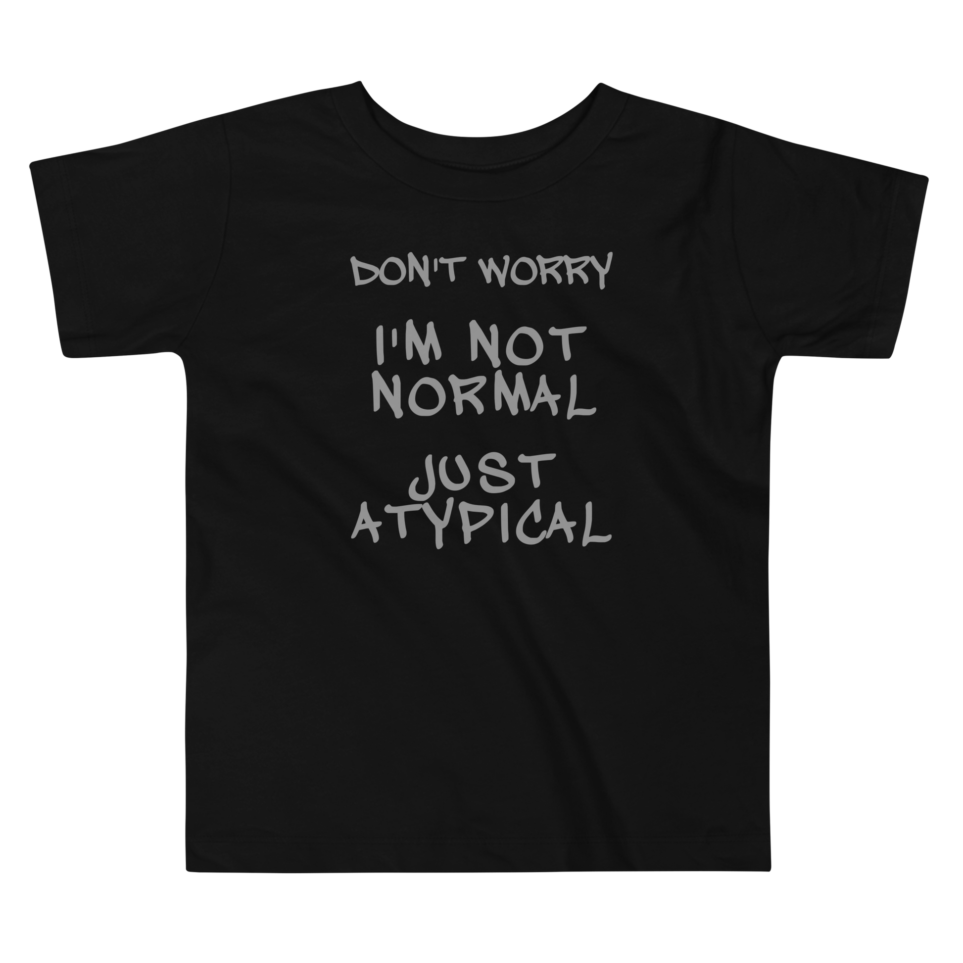 "Don't Worry I'm Not Normal Just Atypical" printed on a black toddler short sleeve tee laying on a flat surface