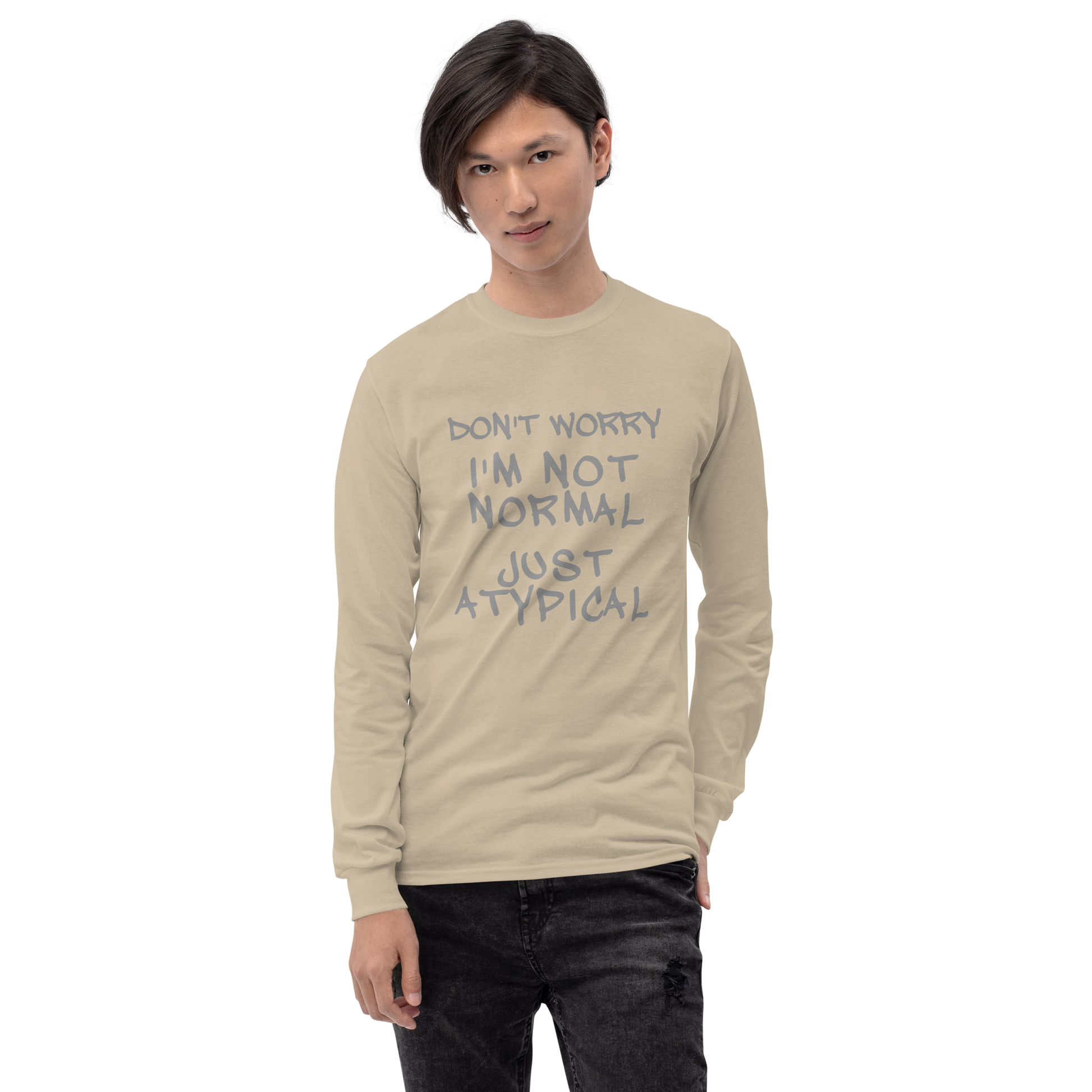 "Don't Worry I'm Not Normal Just Atypical" printed on a sand men's long sleeve shirt worn by a male