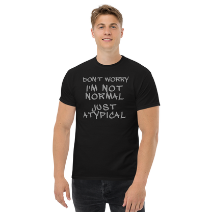 "Don't Worry I'm Not Normal Just Atypical" printed on a black unisex classic tee worn by a male
