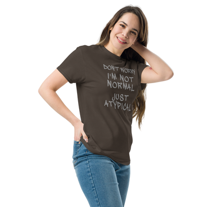"Don't Worry I'm Not Normal Just Atypical" printed on a dark chocolate unisex classic tee worn by a female