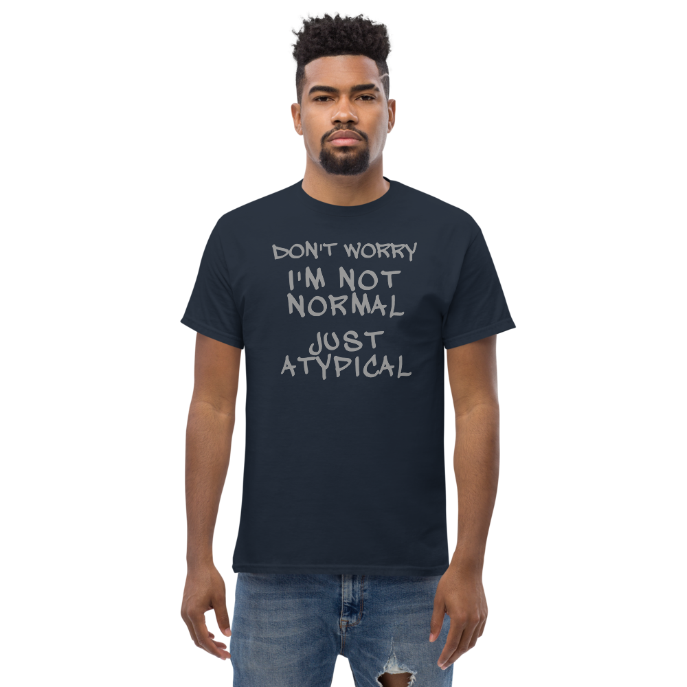 "Don't Worry I'm Not Normal Just Atypical" printed on a navy unisex classic tee worn by a male