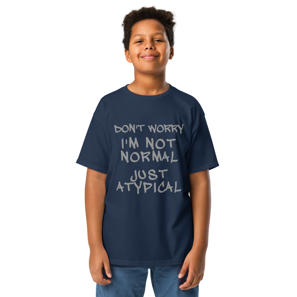 "Don't Worry I'm Not Normal Just Atypical" printed on a navy youth classic tee worn by a male