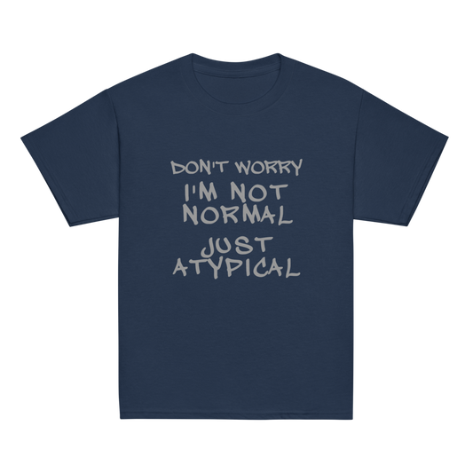 "Don't Worry I'm Not Normal Just Atypical" printed on a navy youth classic tee laying on a flat surface