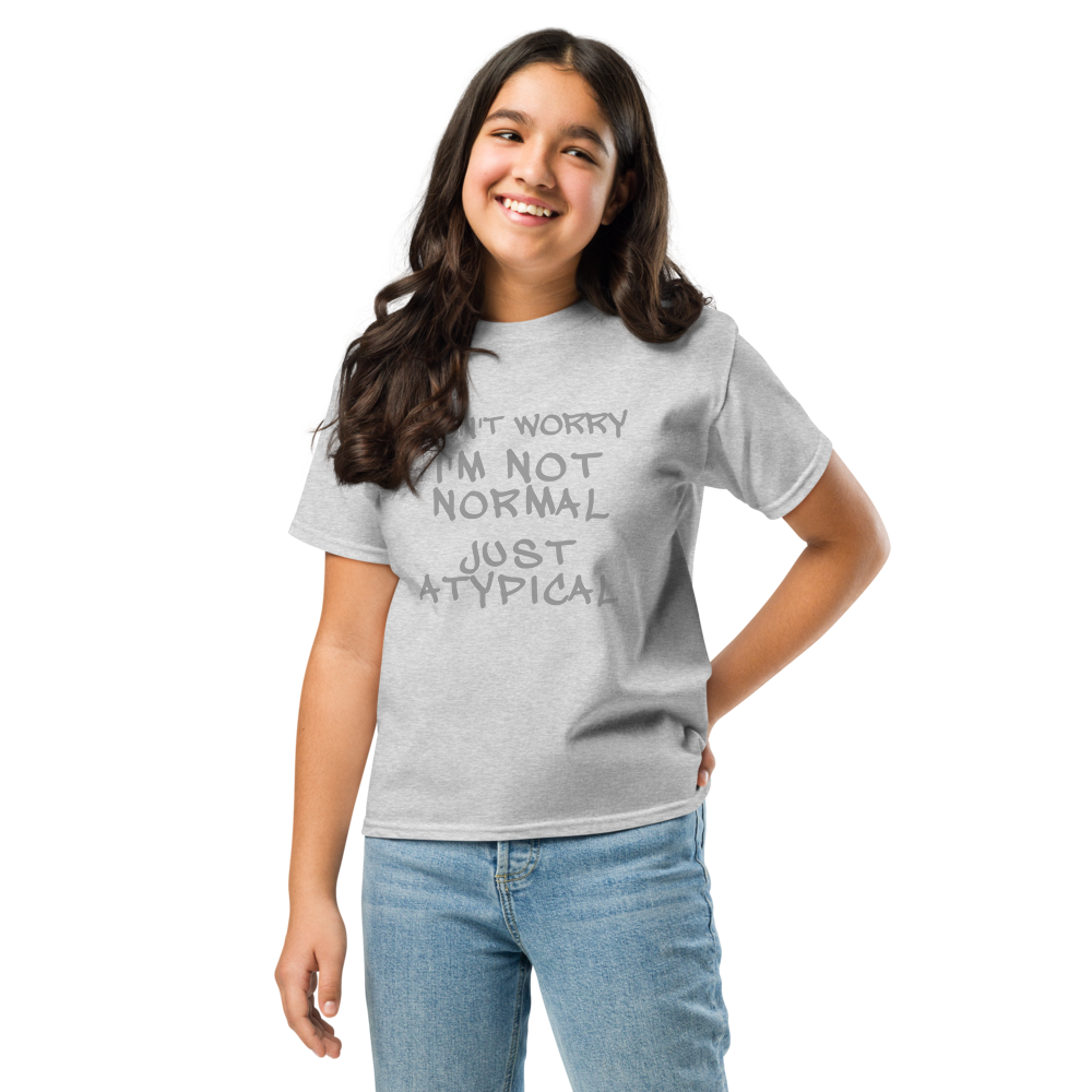 "Don't Worry I'm Not Normal Just Atypical" printed on a sport grey youth classic tee worn by a female