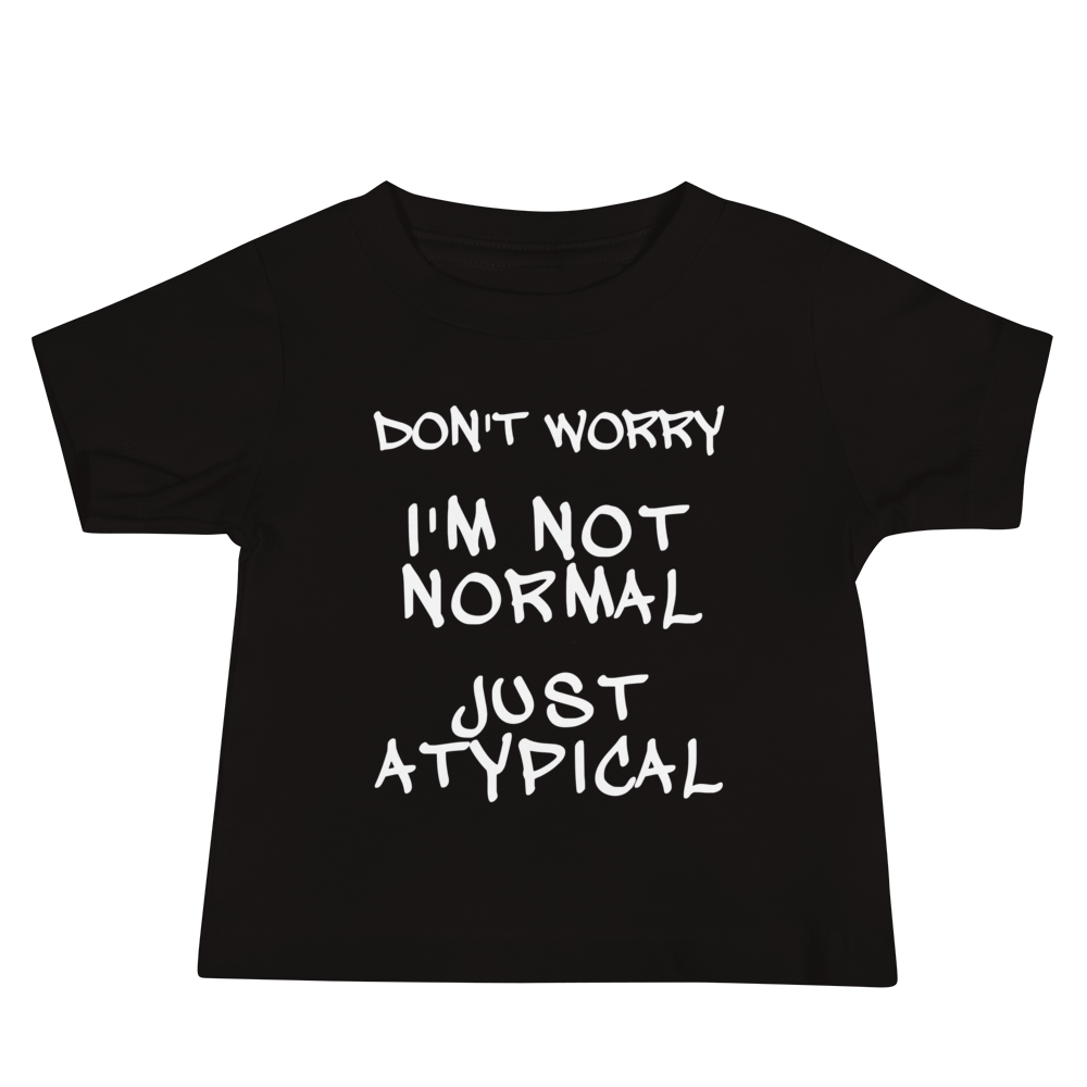 "Don't Worry I'm Not Normal Just Atypical" printed on a black baby jersey short sleeve tee laying on a flat surface