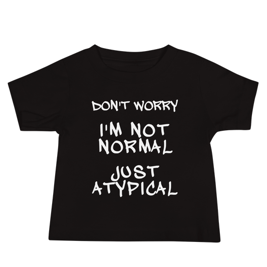 "Don't Worry I'm Not Normal Just Atypical" printed on a black baby jersey short sleeve tee laying on a flat surface