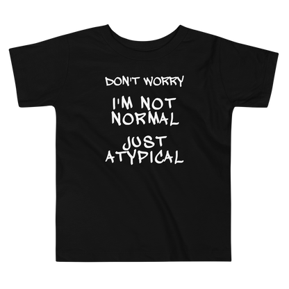 "Don't Worry I'm Not Normal Just Atypical" printed on a black toddler short sleeve tee laying on a flat surface