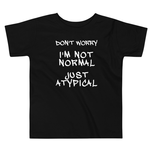 "Don't Worry I'm Not Normal Just Atypical" printed on a black toddler short sleeve tee laying on a flat surface
